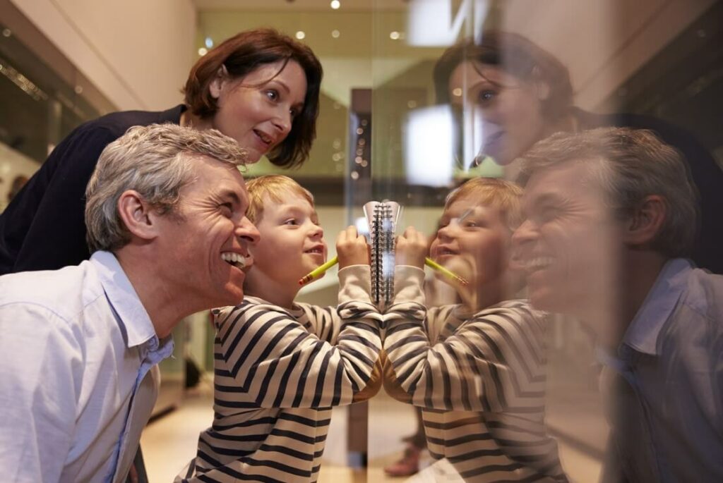 Family looking into glass case during a visit to the museum. 